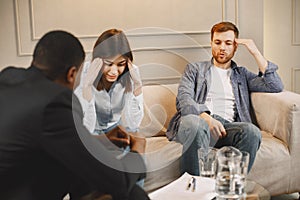 Couple at pshycologist appointment sitting in modern office