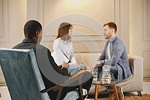 Couple at pshycologist appointment sitting in modern office