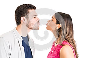 Couple Puckering Lips While Standing Face To Face