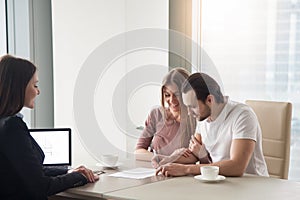 Couple purchasing, renting apartment, signing agreement contract