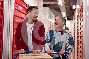 Couple Pushing Cart to Storage Unit