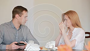 Couple quarrel in a cafe, separation, emotional conversation. Man and woman