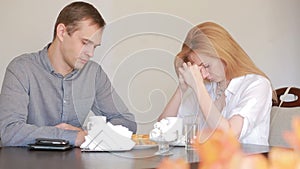 Couple quarrel in a cafe, separation, emotional conversation. Man and woman