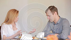 Couple quarrel in a cafe, separation, emotional conversation. Man and woman
