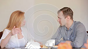 Couple quarrel in a cafe, separation, emotional conversation. Man and woman