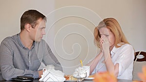 Couple quarrel in a cafe, separation, emotional conversation. Man and woman