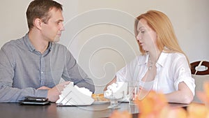 Couple quarrel in a cafe, separation, emotional conversation. Man and woman