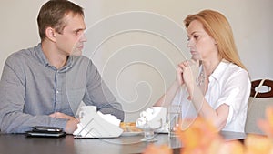 Couple quarrel in a cafe, separation, emotional conversation. Man and woman