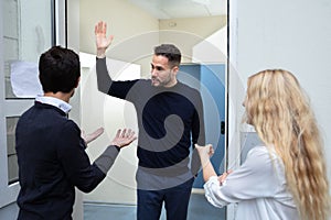 Couple Quarreling With Man Standing Outside The Door photo