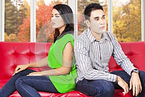 Couple quarreling and sitting separately