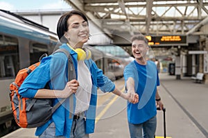 couple at railway station waiting for the train. Woman and man running to board a train