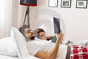 Couple reading in bed