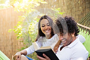 Couple reading book on hammok