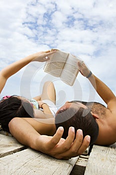 Couple reading book in holiday