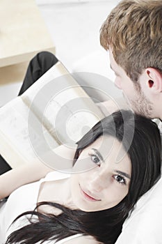 Couple reading book on a sofa