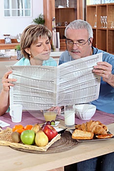 Couple reading the newspaper