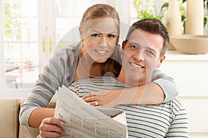 Couple reading newspaper