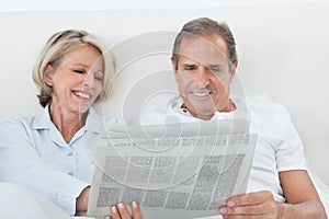 Couple reading newspaper