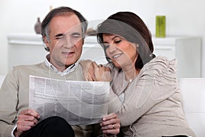 Couple reading the newspaper