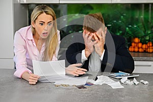 Couple reading terrible news regarding their finances photo