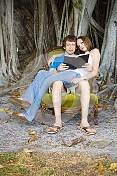 Couple reading under tree