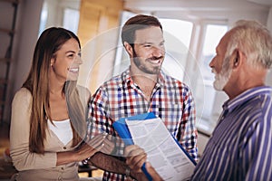 Couple with real-estate agent visiting house for sale