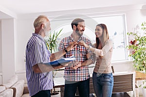 Couple with real-estate agent visiting house for sale