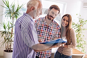 Couple with real-estate agent visiting house for sale