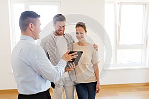 Couple and realtor with tablet pc at new home