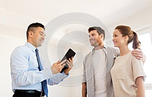 Couple and realtor with tablet pc at new home