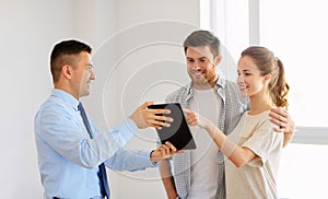 Couple and realtor with tablet pc at new home