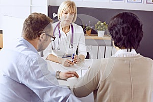 Couple at reception discussing issues with a sexologist photo