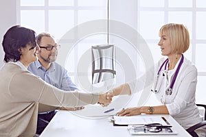 Couple at reception discussing issues with a sexologist photo