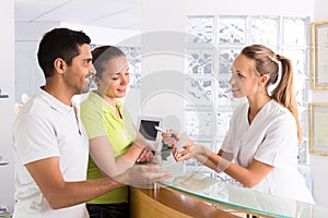 Couple with receptionist at clinic photo