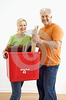 Couple with recycling bin.