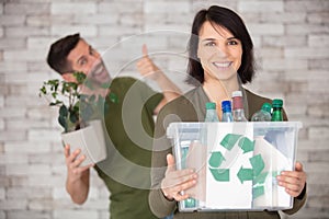 couple recycling empty plastic bottles