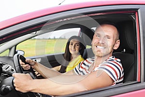 Couple in a red car