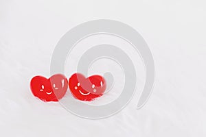Couple red heart with a smiling face on soft white wool table background.Concept of love in the lovers of the festival of