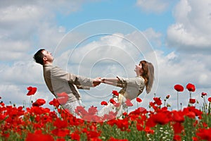 Couple on red poppies field