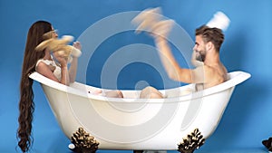 Couple relationship concept. Family life routine. Man and woman playing in bath. Happy couple.
