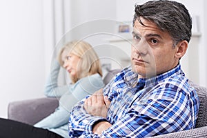 Couple With Relationship Difficulties Sitting On Sofa photo