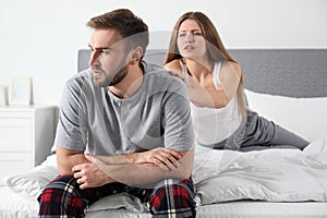 Couple with relationship problems in bedroom