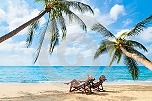 Couple relax on the beach enjoying beautiful sea on the tropical island photo