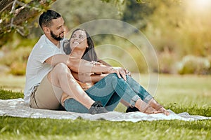 Couple relax on grass, outdoor picnic in park and love sitting on blanket in Miami garden under a tree. Romantic date in