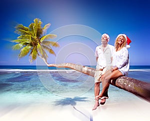 Couple Relaxing on the Beach Honeymoon Concept