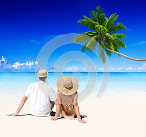 Couple Relaxing on the Beach Honeymoon Vacation Concept