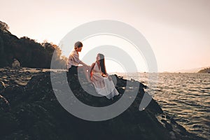 Couple relaxing beautiful sunset on Koh Lipe Beach Thailand ,Summer vacation