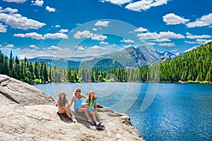 Couple relaxing and enjoying beautiful view of hot spring on hiking trip.