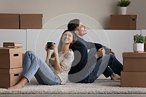 Couple relaxing on floor with cups on relocation day