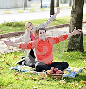 Couple Relaxing on the Grass and Eating Apples photo